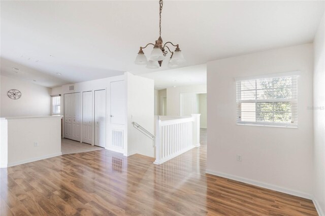 unfurnished room featuring light wood finished floors, visible vents, baseboards, and a wealth of natural light