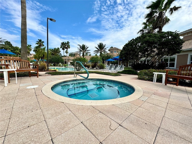 pool featuring a patio area and a hot tub