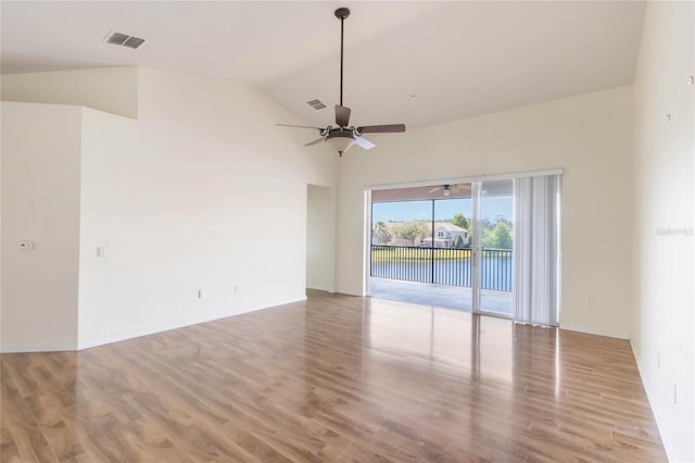 empty room with wood finished floors, visible vents, and a ceiling fan