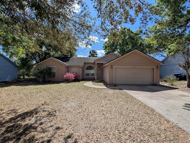 ranch-style home featuring driveway, an attached garage, and stucco siding