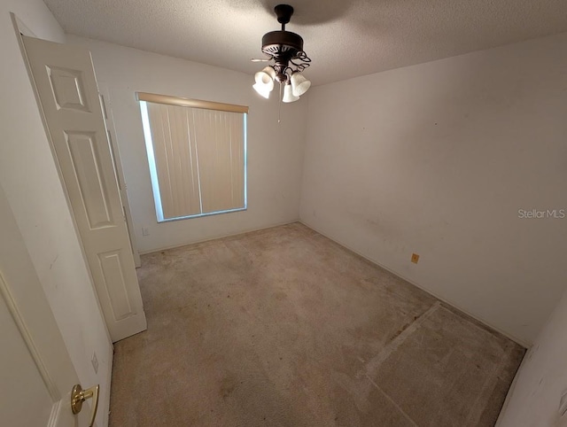 carpeted spare room featuring a textured ceiling