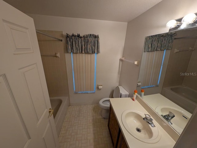 bathroom with a textured ceiling, vanity, toilet, and shower / bathtub combination