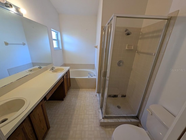 bathroom with a garden tub, a sink, toilet, and a shower stall