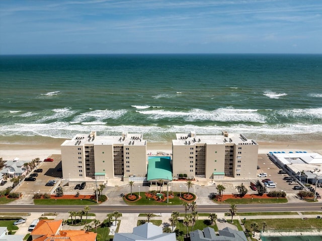 drone / aerial view featuring a view of the beach and a water view