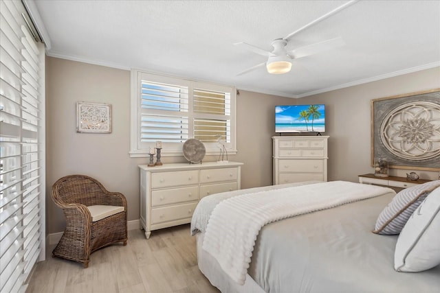 bedroom with baseboards, a ceiling fan, light wood-style floors, and ornamental molding