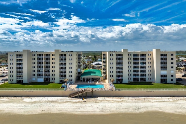 view of building exterior featuring a community pool