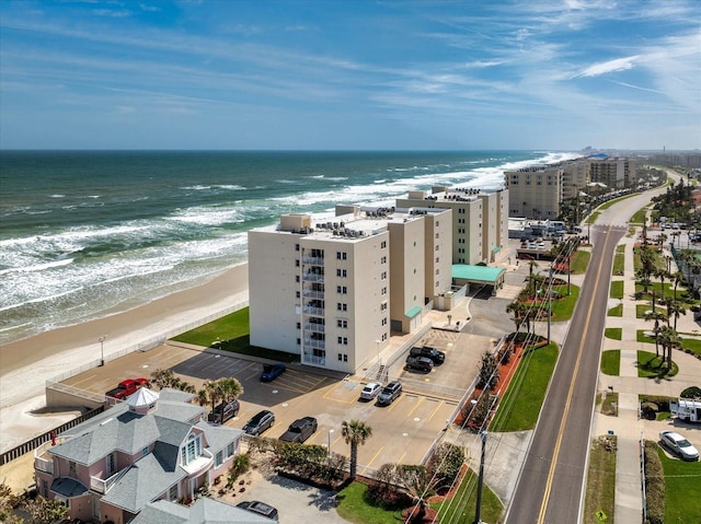 aerial view with a water view, a city view, and a beach view