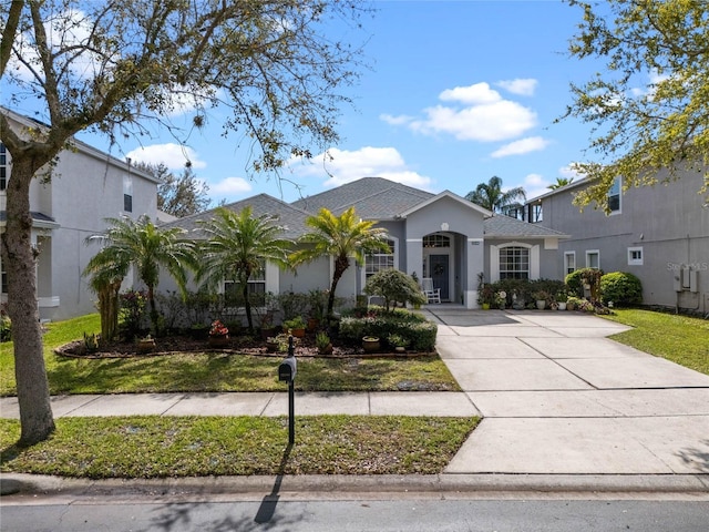 view of front facade with a front lawn and stucco siding