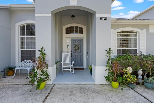 entrance to property featuring stucco siding