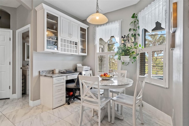 dining room featuring marble finish floor and baseboards