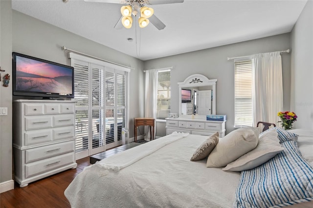 bedroom with ceiling fan, multiple windows, baseboards, and dark wood-style flooring