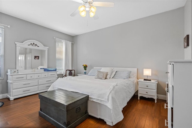 bedroom featuring ceiling fan, dark wood finished floors, and baseboards