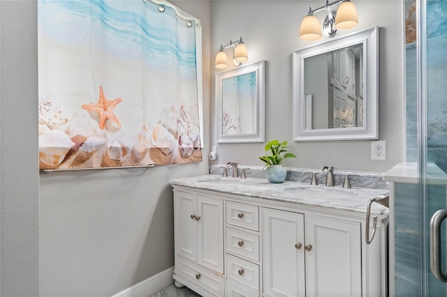 bathroom featuring double vanity, a sink, and baseboards