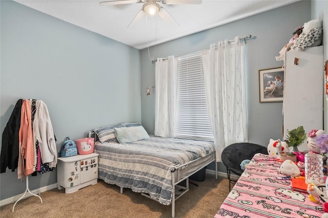 bedroom with ceiling fan, carpet flooring, and baseboards