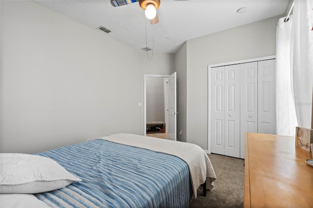 carpeted bedroom featuring ceiling fan, a closet, and visible vents