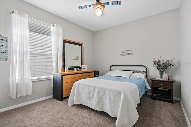 bedroom featuring light carpet, baseboards, and a ceiling fan