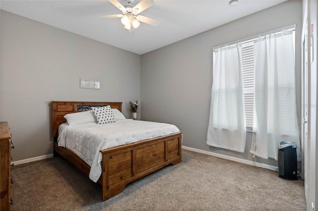 bedroom with a ceiling fan, carpet, and baseboards