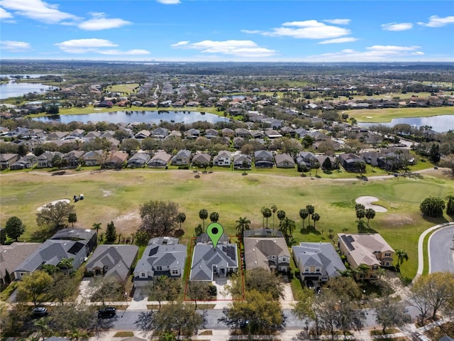 drone / aerial view featuring a water view and a residential view