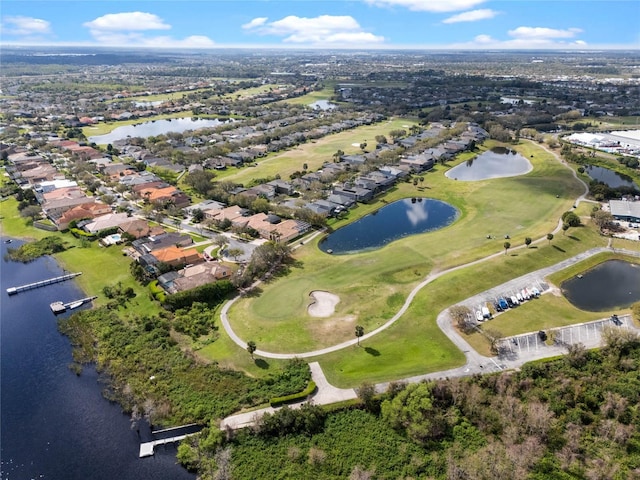 drone / aerial view featuring view of golf course, a water view, and a residential view