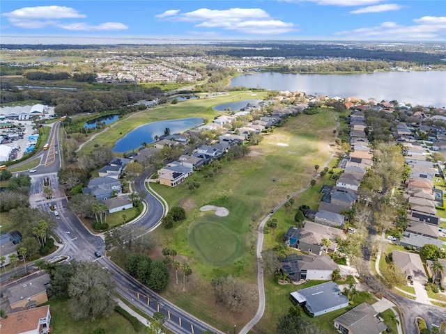 drone / aerial view featuring a residential view, a water view, and golf course view