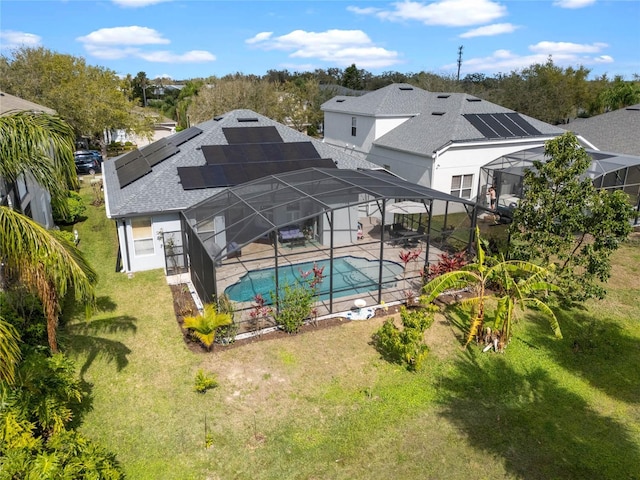 pool featuring a lanai, a patio area, and a yard