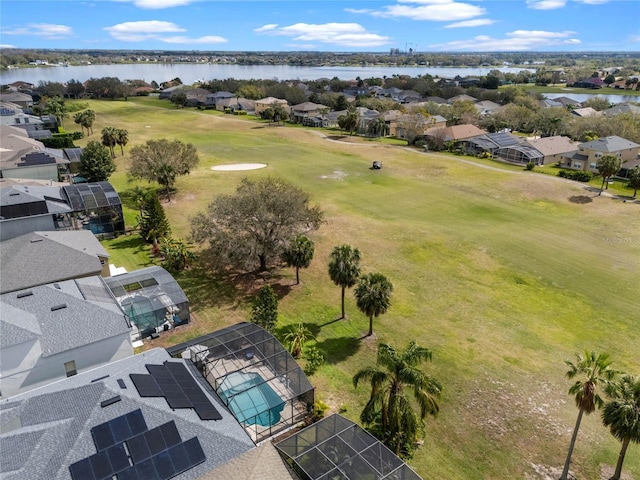 birds eye view of property featuring view of golf course, a water view, and a residential view