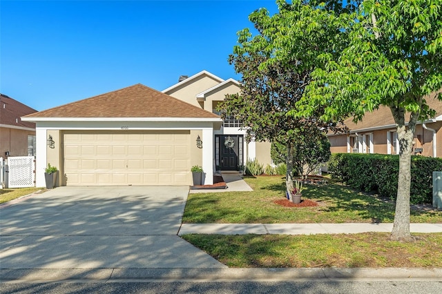 view of front facade with a shingled roof, a garage, driveway, and stucco siding