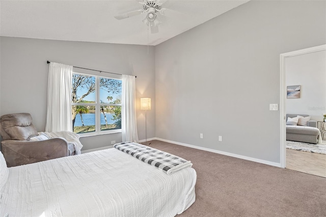 carpeted bedroom featuring ceiling fan, baseboards, and lofted ceiling