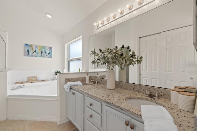 full bath with double vanity, lofted ceiling, a sink, tile patterned floors, and a bath