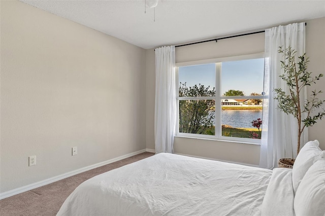 carpeted bedroom with baseboards