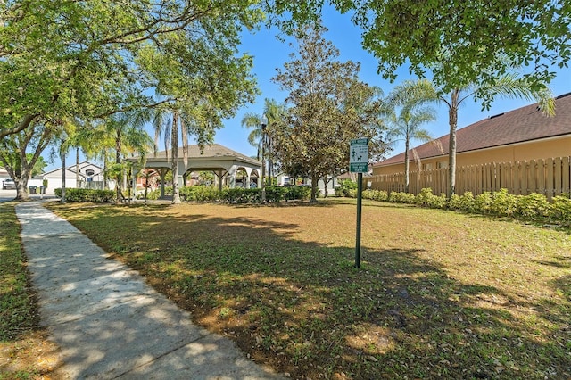 surrounding community featuring a gazebo, a yard, and fence