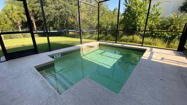 view of pool with glass enclosure, a yard, and a patio area