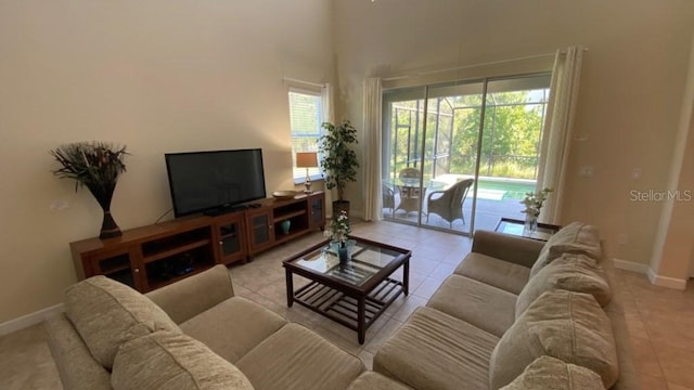 living room featuring baseboards and light tile patterned flooring