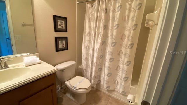 full bathroom featuring tile patterned floors, toilet, shower / tub combo with curtain, and vanity