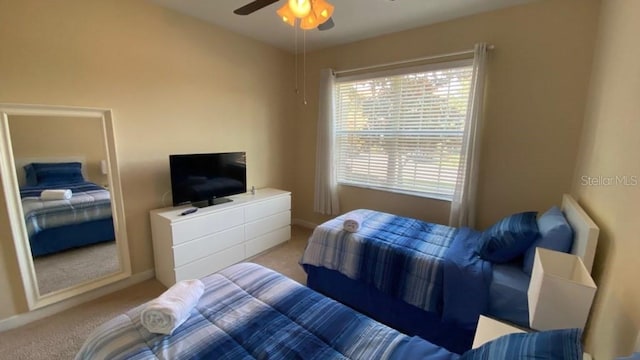 carpeted bedroom with baseboards and a ceiling fan