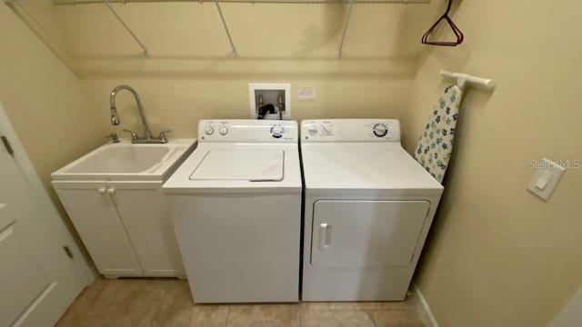 laundry area with laundry area, a sink, and separate washer and dryer