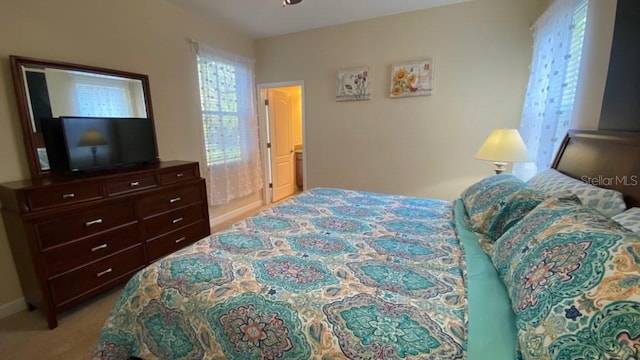 bedroom featuring light carpet