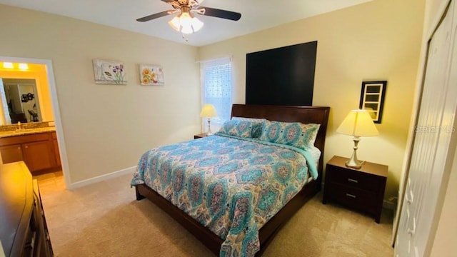 bedroom featuring light colored carpet, baseboards, a closet, and ceiling fan