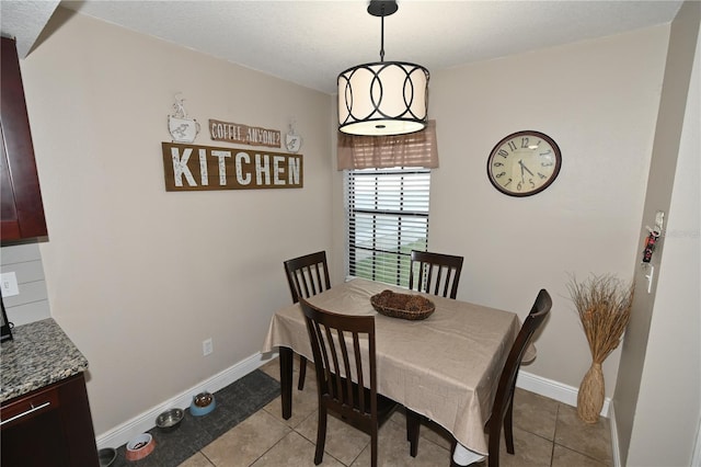 dining room featuring light tile patterned flooring and baseboards