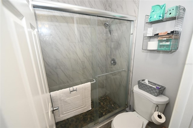 bathroom with a marble finish shower and toilet