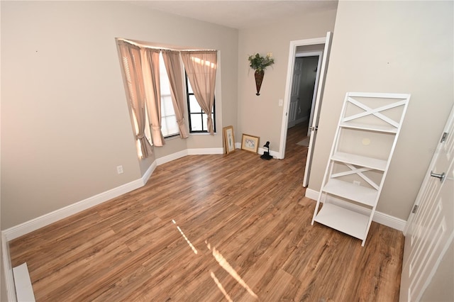 empty room featuring light wood-style floors and baseboards