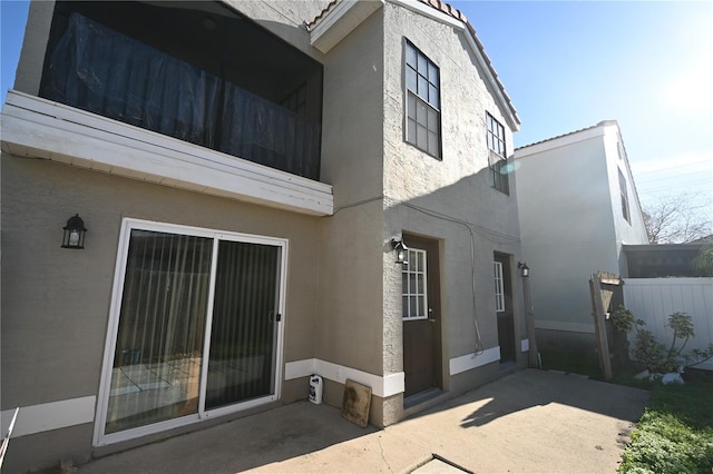 back of house featuring a patio area, stucco siding, and fence