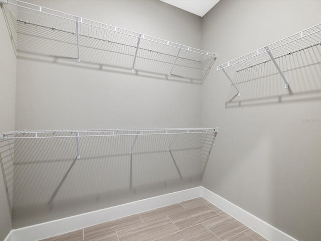 spacious closet featuring wood finish floors