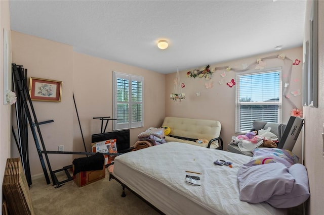 bedroom featuring multiple windows, carpet, and baseboards