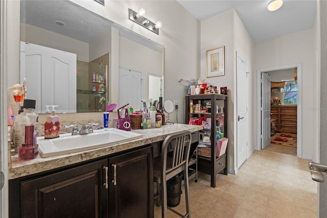 bathroom with vanity, baseboards, and walk in shower