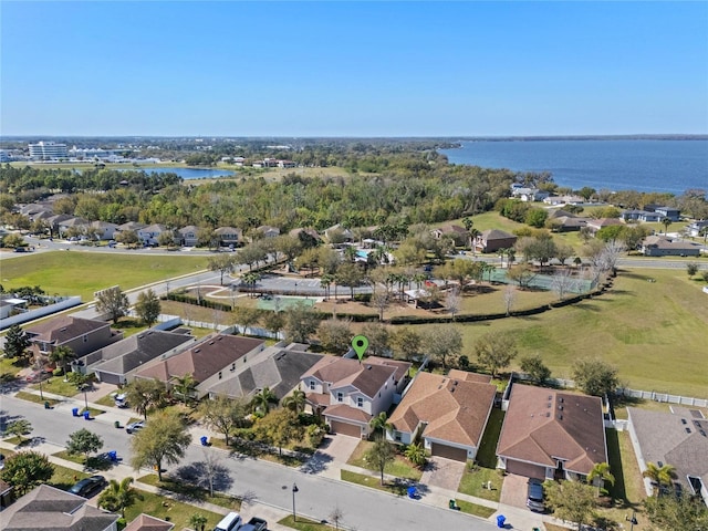 drone / aerial view featuring a residential view and a water view