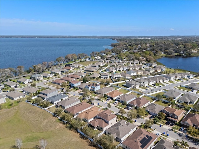 bird's eye view featuring a water view and a residential view