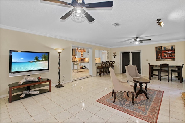 living room with light tile patterned floors, visible vents, ornamental molding, a textured ceiling, and baseboards