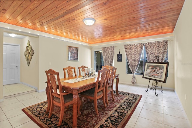 dining area featuring wooden ceiling, baseboards, and light tile patterned floors