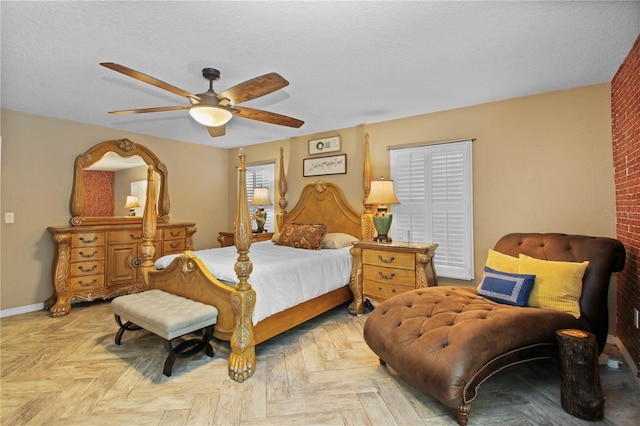 bedroom featuring a ceiling fan, a textured ceiling, and baseboards